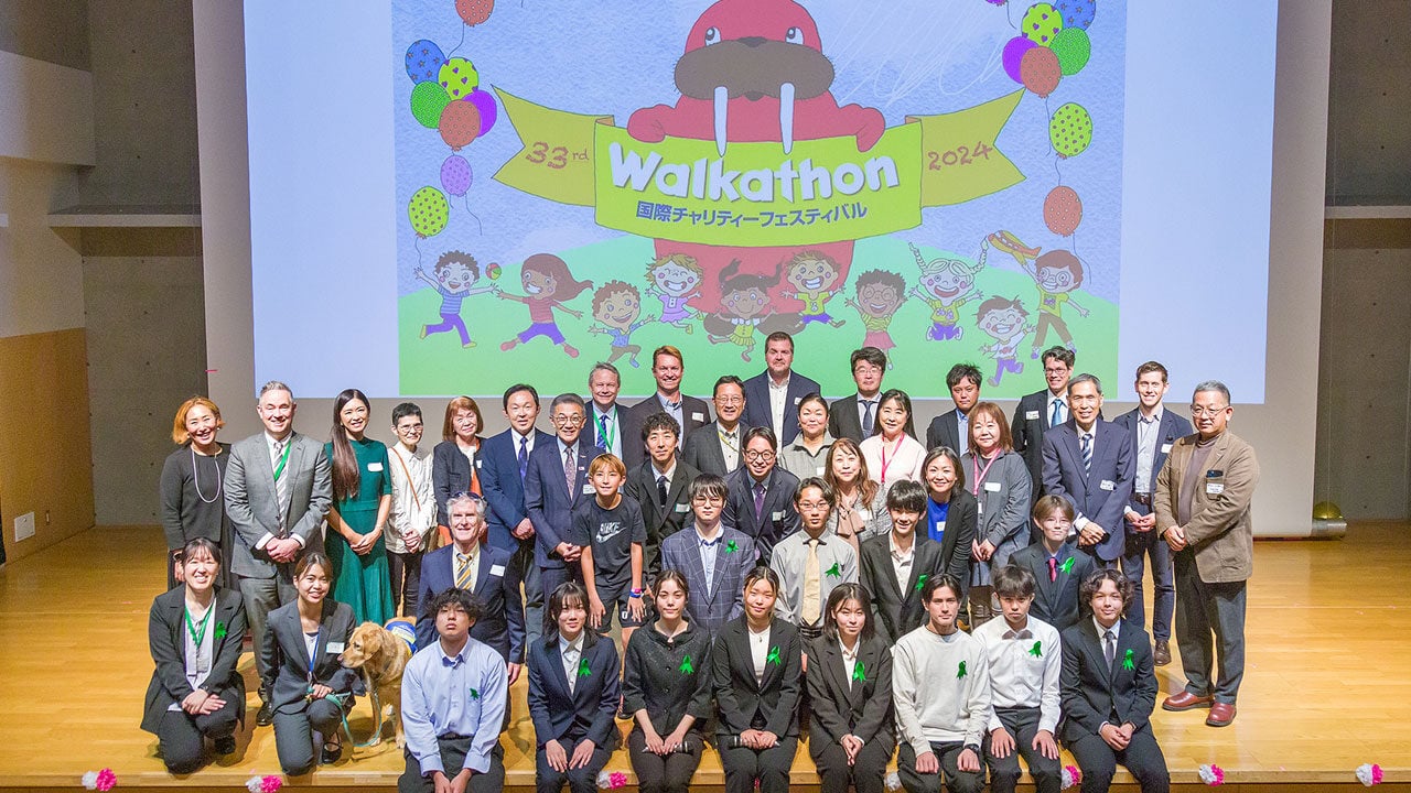 NIS students presenting walk-a-thon fundraising money