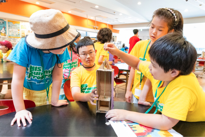 Students experiment with pulleys in the NIS summer program