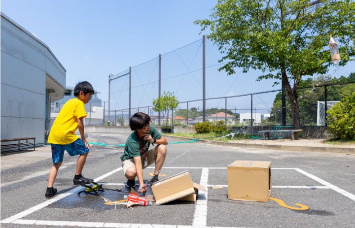 students test their rockets made at NIS Summer Program