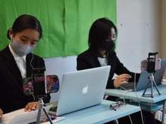 Girls sitting in front of their computers and researching
