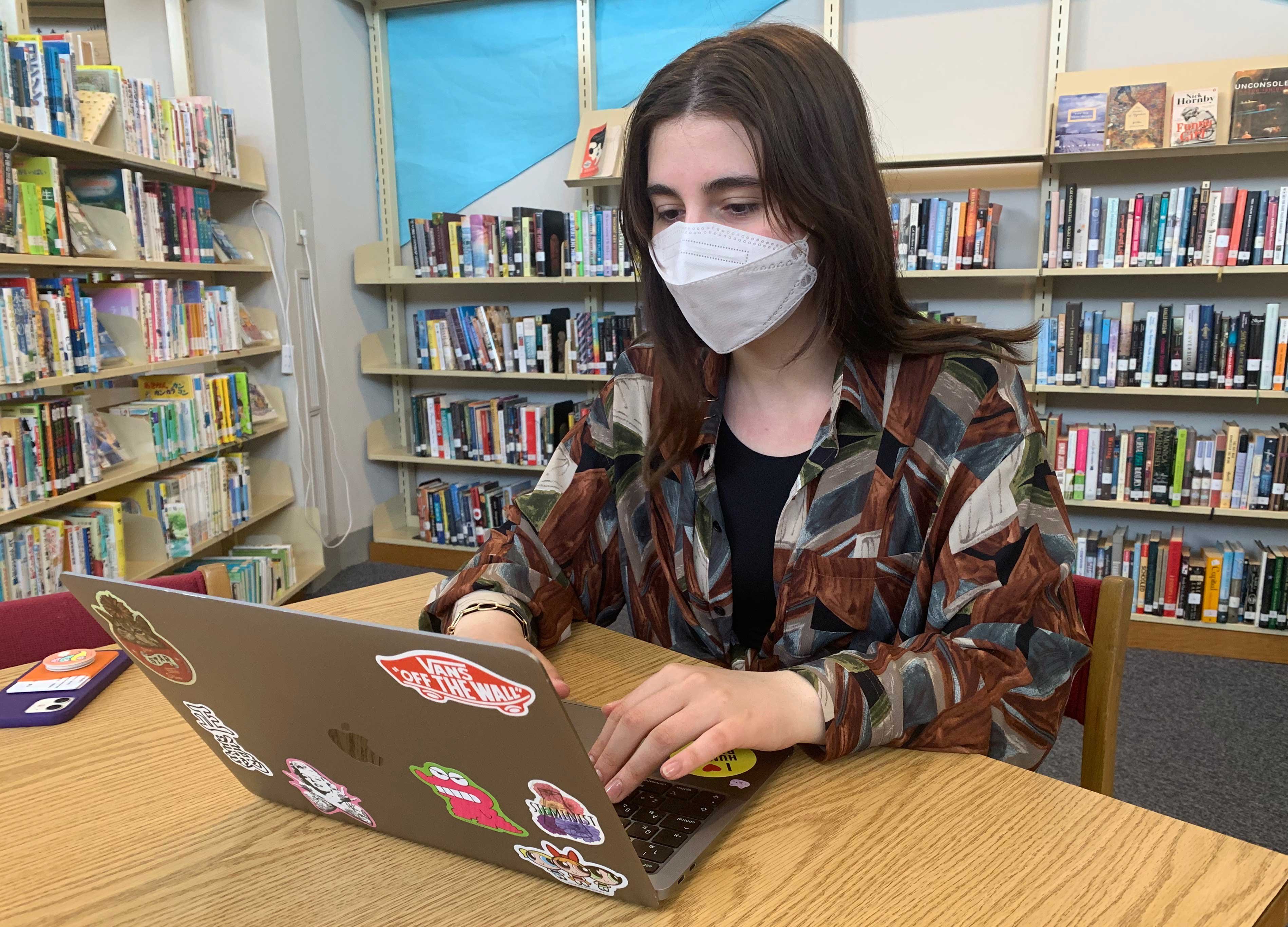 A student studies online in the school library.