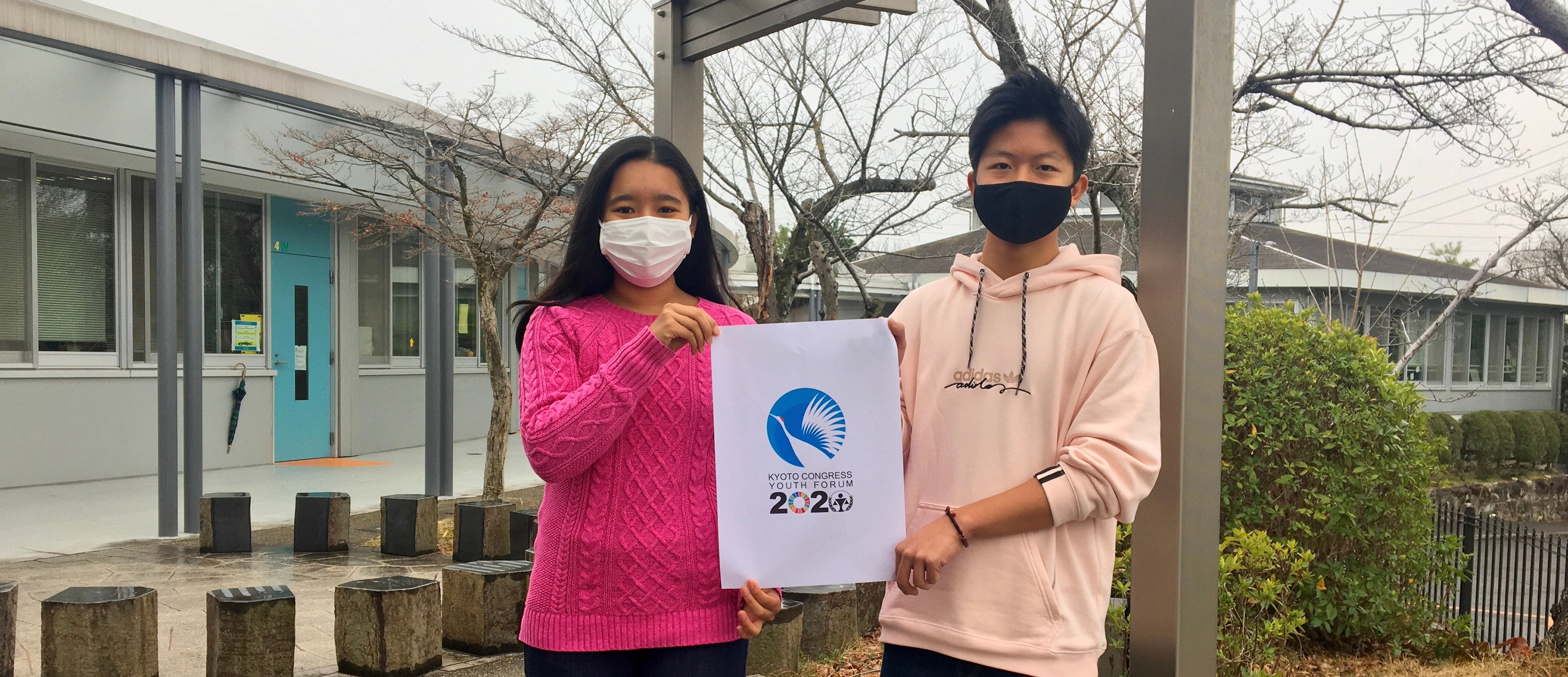 A boy and a girl holding a poster of Kyogo Congress Youth Forum