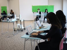 girls sitting in front of their computers and attending an online conference