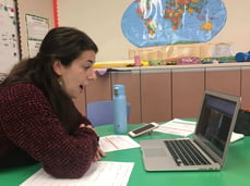 A teacher having online conference with a student and his parents