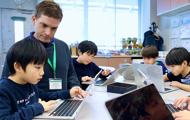 NIS_teacher_working_with_students