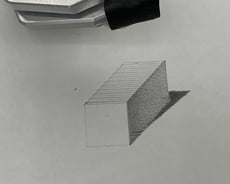 A pencil sketch of a rectangular cuboid drawn by a robotic arm