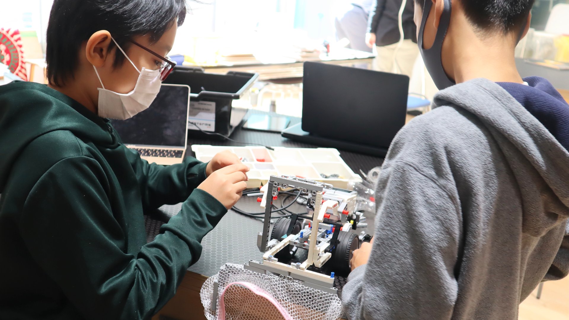 Boys creating a water cleaning robot for their SDGs project