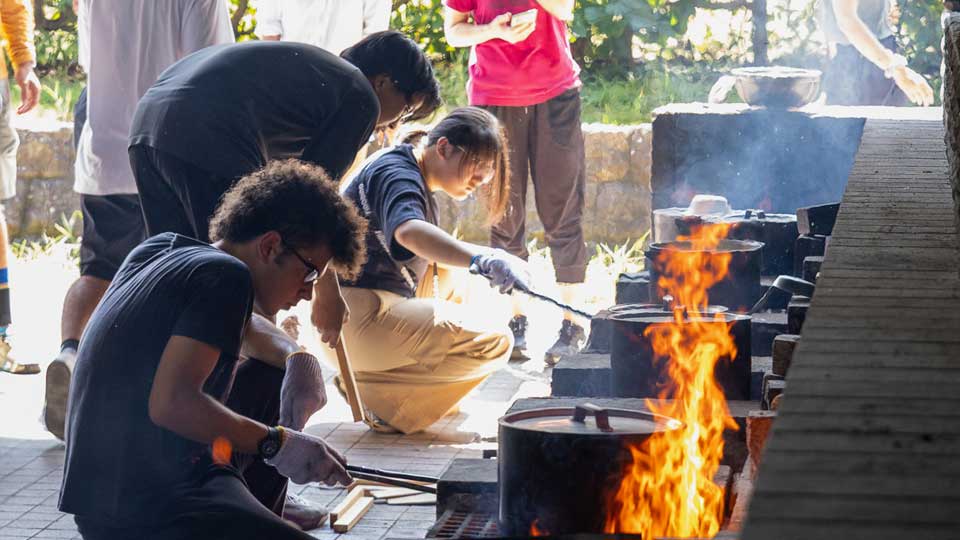 nis student cook dinner during student retreats