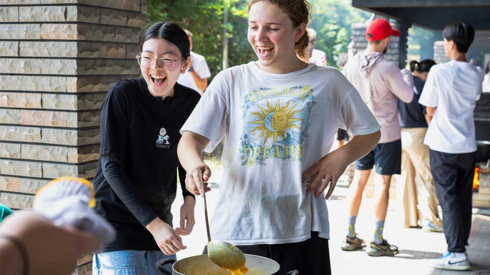 nis student cook dinner during student retreats
