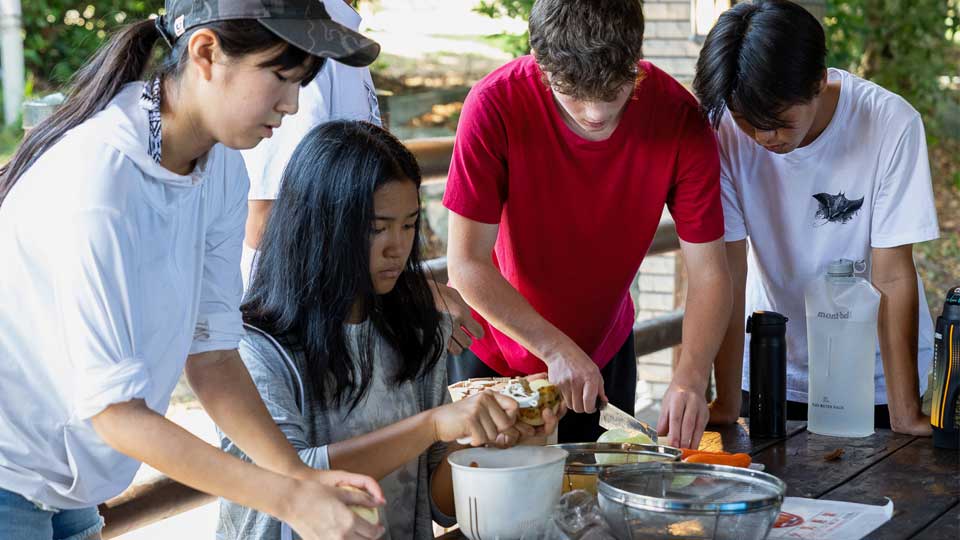nis student cook dinner during student retreats